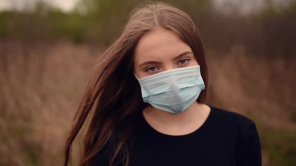 Woman in Protective Mask Hair Fluttering in the Wind Pandemic Covid19 Coronavirus