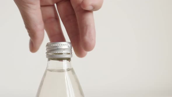 Opening glass bottle with fingers 4K footage