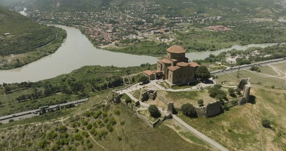 Ancient Jvari Monastery Overlooking Mtskheta Town And Mtkavari River In Georgia. Aerial Drone Shot