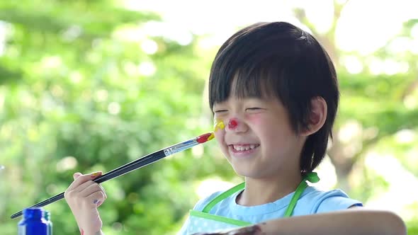 Close Up Of Asian Child Painting On His Face