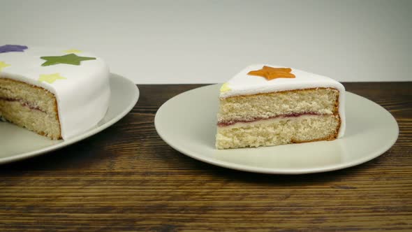 Iced Cake And Slice On Table