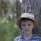 Boy leaning against tree trunk, portrait - VideoHive Item for Sale