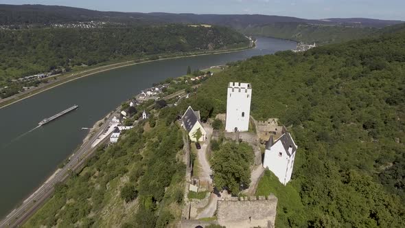 Drone flight close to an old castle on a mountain above a german village.