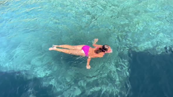 Young Girl Swimming in Clear Turquoise Sea Water