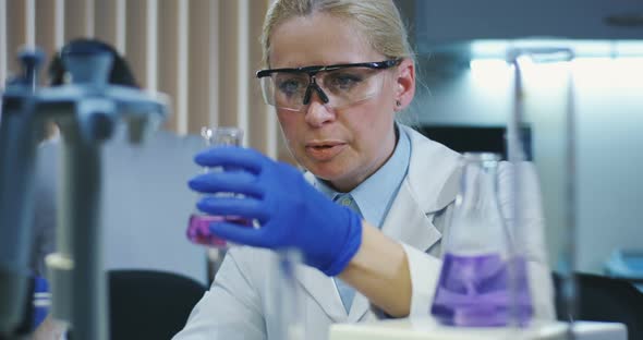 Scientists Examining Various Liquids