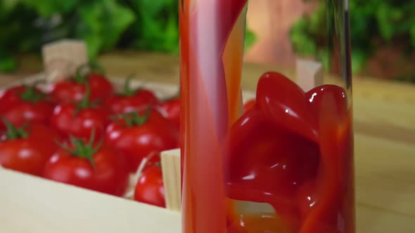 Delicious Tomato Juice is Poured in a Jug Next to Wooden Box Full of Tomatoes