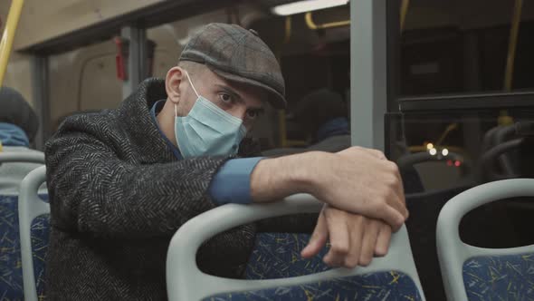 Tired and Depressed Young Man Sitting Alone Near the Transport Window