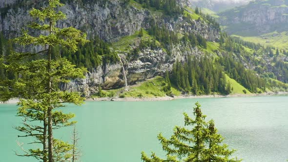 Flying over tree tops towards a beautiful lake in a mesmerizing landscape