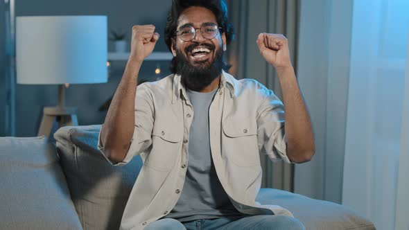 Arabic Happy Motivated Man Watching TV at Home at Night Late in Evening