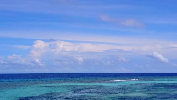 Aerial drone scenery of tourist beach by clear sea with sand background