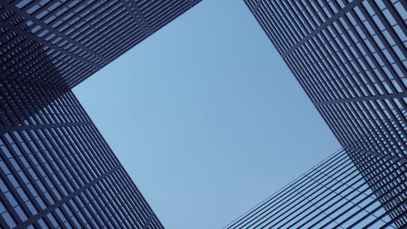 Airplane flies over office skyscrapers against a beautiful blue