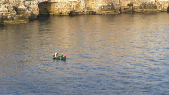 Fishermen On A Small Boat Floating On The Adriatic Sea In Polignano a Mare, Apulia, Italy. Seaside C