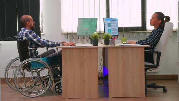 Businesswoman Talking with Paralysed Colleague