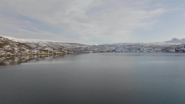 lonely cold landscape. Far away land. Snow mountains and sea. aerial establisher