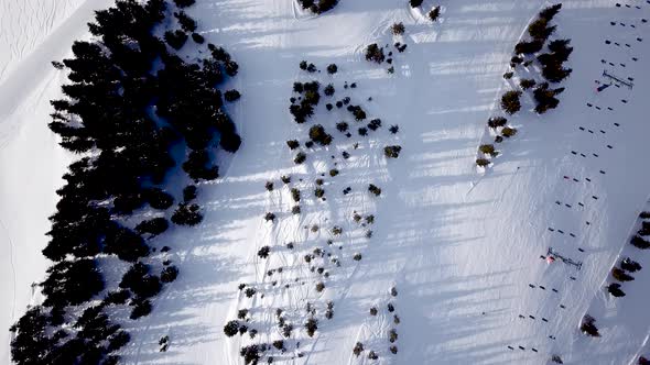 People skiing and snowboarding on snow slope in winter ski resort. Ski elevator on snow mountain. Wi