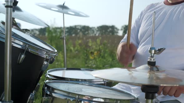Professional Drummer Playing on the Drum Kit Outdoors
