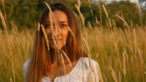 A Beautiful Woman in A White Dress Walking on The Tall Grass