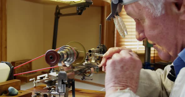 Horologist repairing a watch