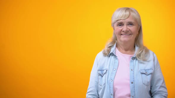 Cheerful Retiree Woman Holding Football Ball, Sports Betting, Positive Attitude