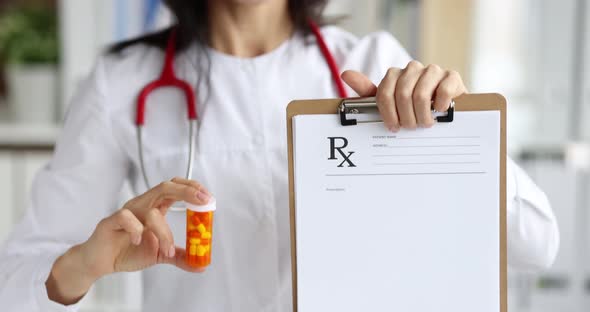 Doctor Holding Prescription on Clipboard and Jar of Medicine Closeup  Movie Slow Motion