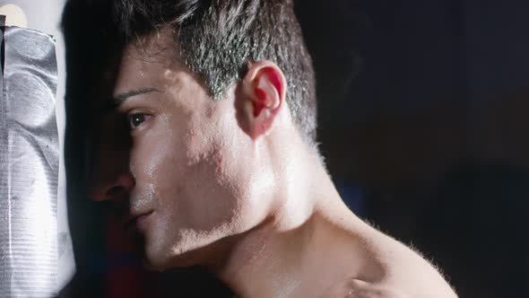 Athletic Man Leaning His Forehead to Sandbag While Having Break