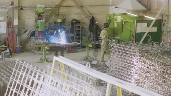 Welders working at metal manufacture