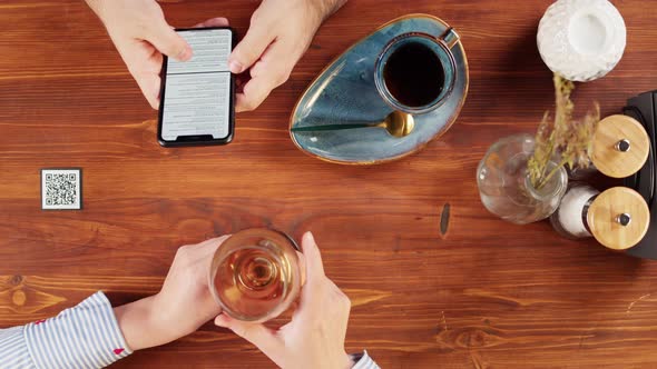 Man Using Online Menu in Cafe Top View Scanning Qr Code with Smartphone in Restaurant