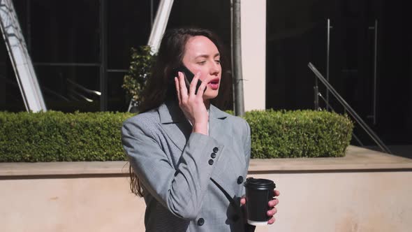 Portrait of Businesswoman Talking Phone at Street