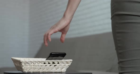 Woman Puts Telephone on Table