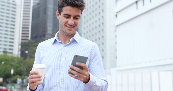 Man hold with mobile phone and drink of coffee