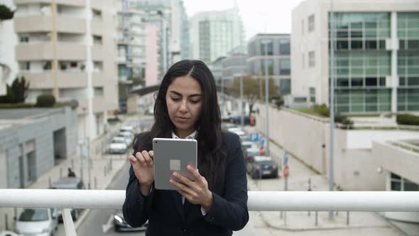 Young Businesswoman Using Tablet Pc on Bridge