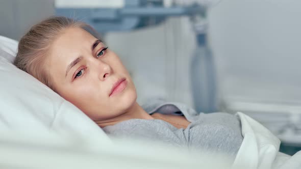 Young Female Patient Lying in a Hospital Room