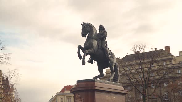 Statue of Warrior Riding a Horse With Ancestral Building at the Background in  Budapest Hungary - wi