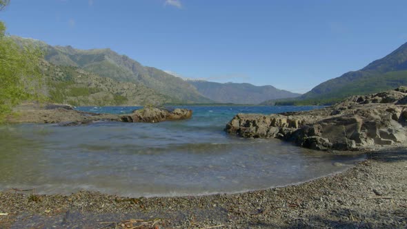 Turquoise rough waters on a  windy day. Emerald Lake Epuyen. Patagonia Argentina. Timelapse Slider m