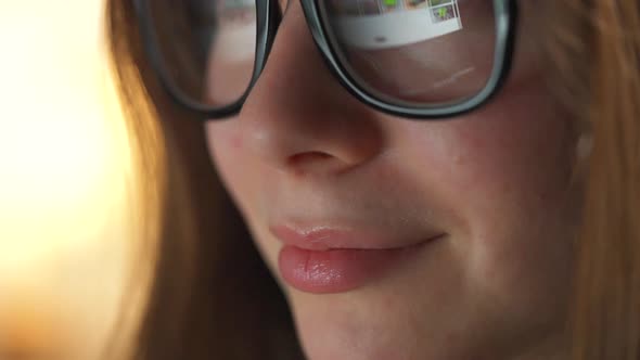 Woman in Glasses Looking on the Monitor and Surfing Internet