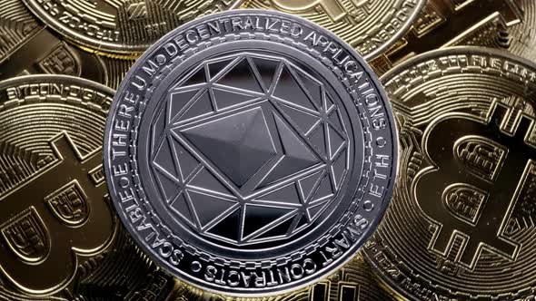 ETH, Ethereum coin on bitcoins background, cryptocurrency investing concept.