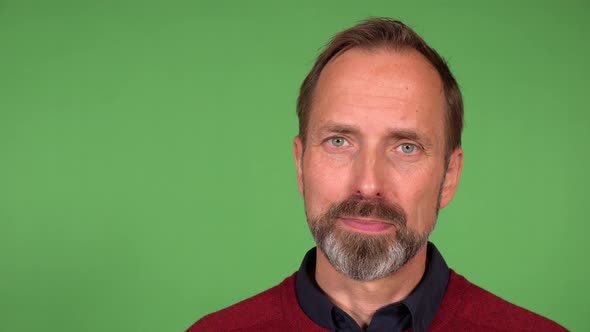 A Middleaged Handsome Caucasian Man Talks to the Camera with a Smile  Closeup  Green Screen