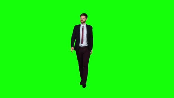 Businessman Is Going To a Meeting and Waving Greetings. Green Screen