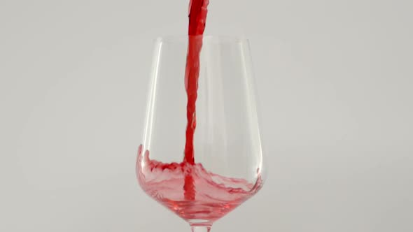 Close Up Shot of Pouring Red Wine in Glass at 1000 Fps White Background