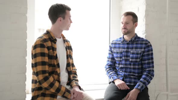 Talking Young People Sitting in Window