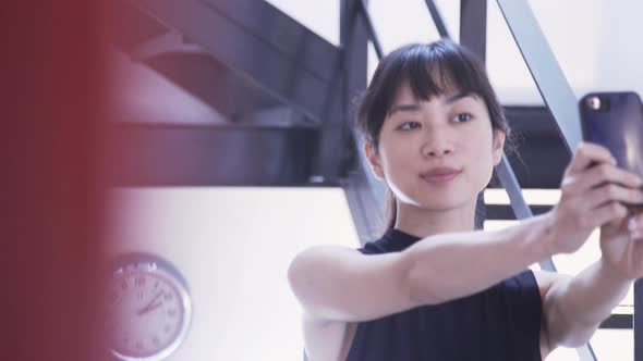 Woman taking selfie using smart phone