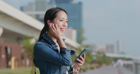 Woman Talk to Smart Phone in City