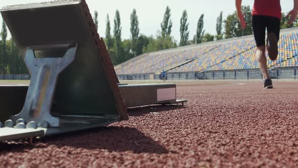 Athlete Beginning to Run from Starting Blocks at Competition, Slow-Motion