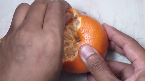 Taking Skin Off From a Orange 