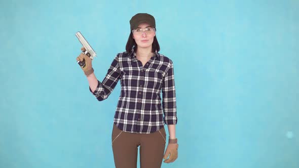 Girl Shooter with Gun and Glasses Looking at Camera Smiling