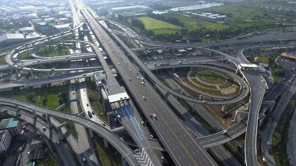 Aerial View of Highway Road Interchange with Busy Urban Traffic Speeding on Road