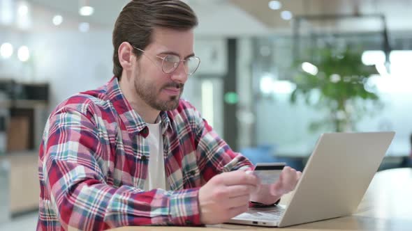 Male Designer with Successful Online Payment on Laptop