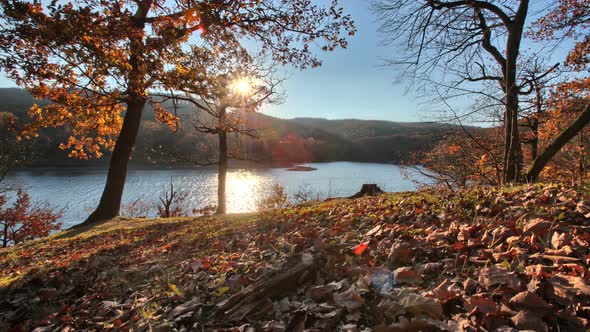 Time lapse of a beautiful shining sun over a lake in autumn