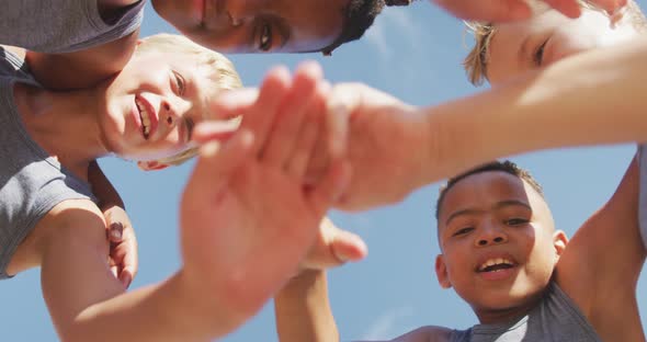 Video of happy diverse boys holding arms and clapping hands alt