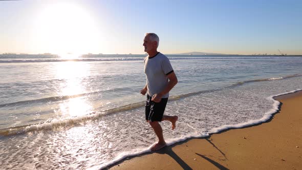 Senior Man Exercising At The  Beach